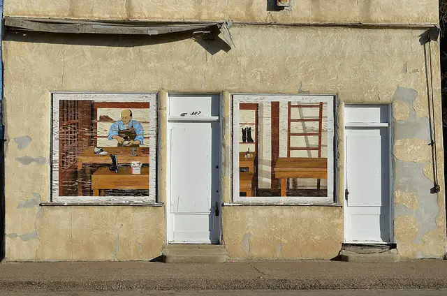 Shoe repair shop facade with cobbler painting